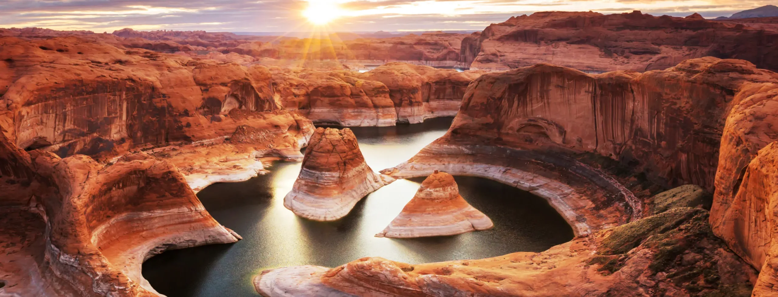 landscape picture of a barren mountain range surrounding a body of water
