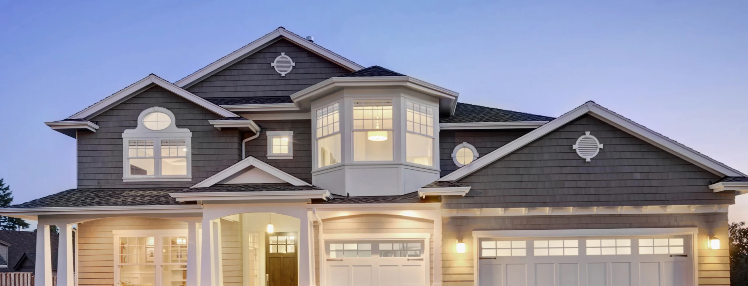 picture of a home front with all the lights on