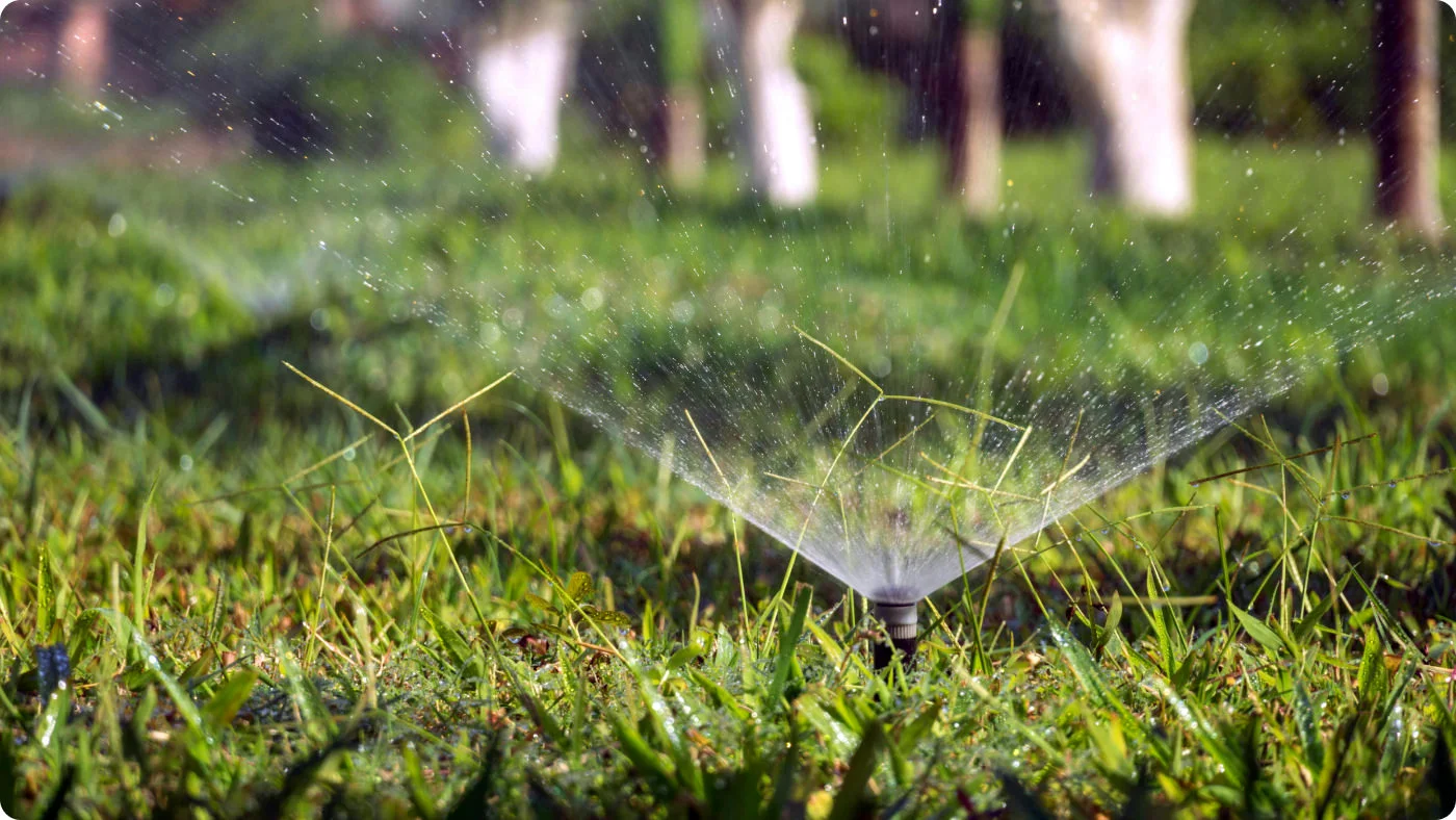 picture of a water sprinkler running on a lawn